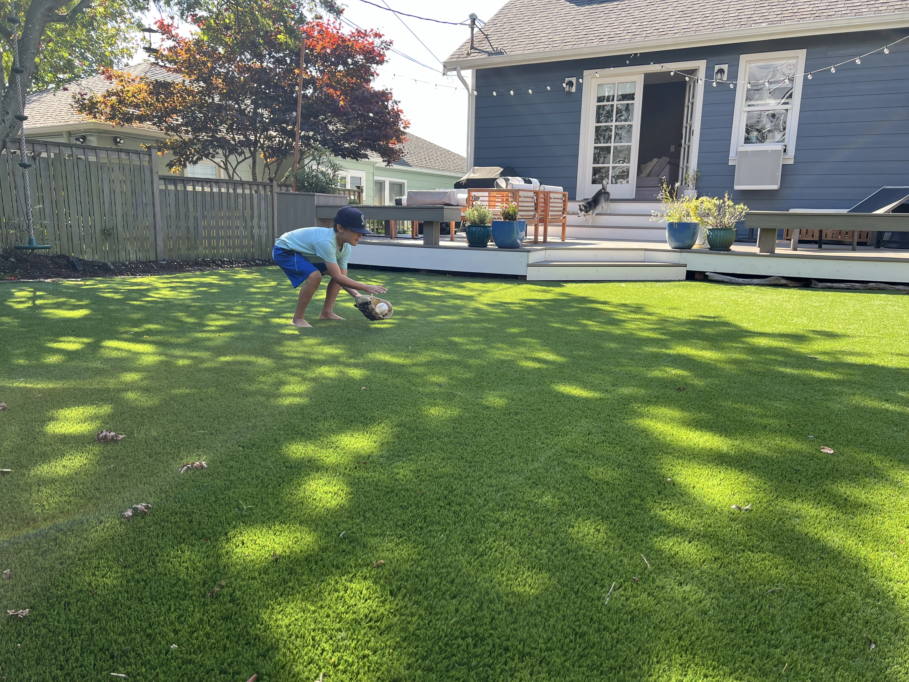 A family using their completed backyard turf lawn, photographed by Tony Johnson